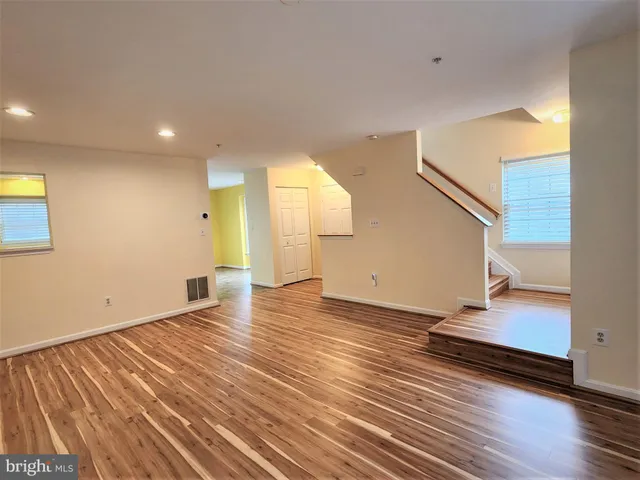 a view of a room with wooden floor