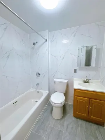 a bath room with a toilet a sink and a bathtub