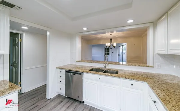 a bathroom with a granite countertop sink a mirror and a shower