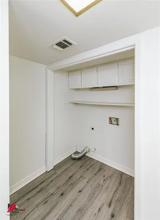 a view of storage and utility room with wooden floor