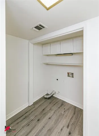 a view of storage and utility room with wooden floor