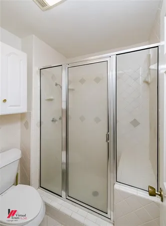 a bathroom with a shower a toilet and a sink