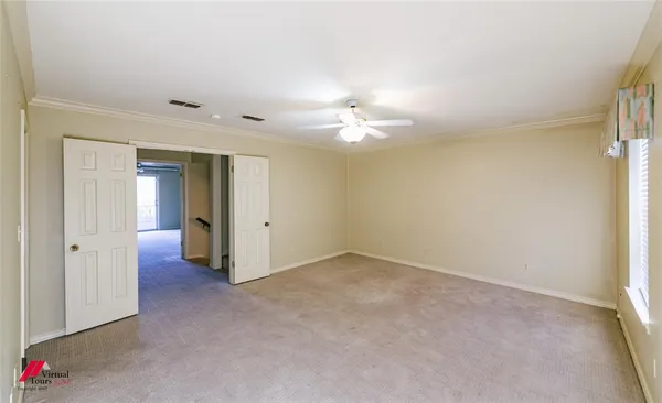 a view of a livingroom with a chandelier fan and a window