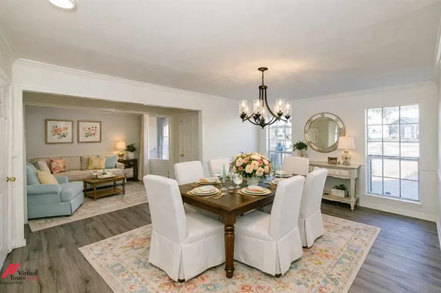 a living room with fireplace furniture and wooden floor