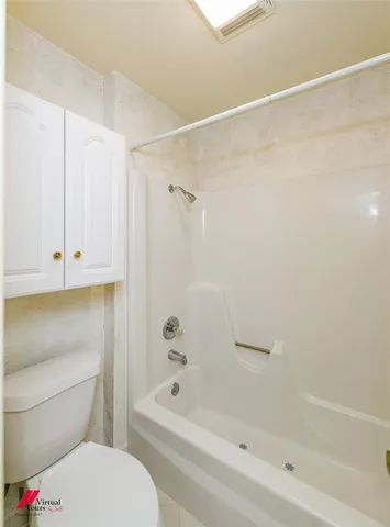 a bathroom with a bathtub and a toilet