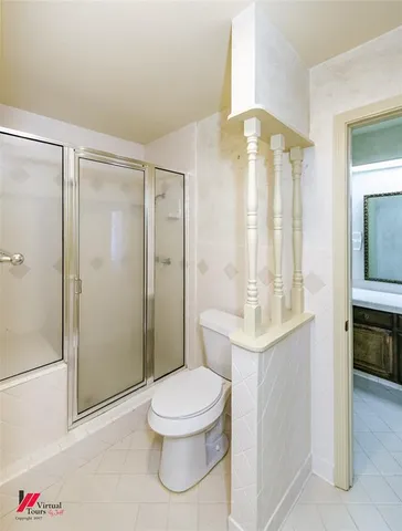 a bathroom with a toilet a sink and shower