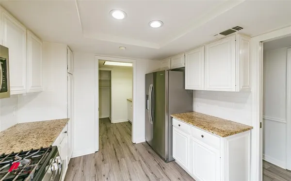 a kitchen with granite countertop a stove and a refrigerator