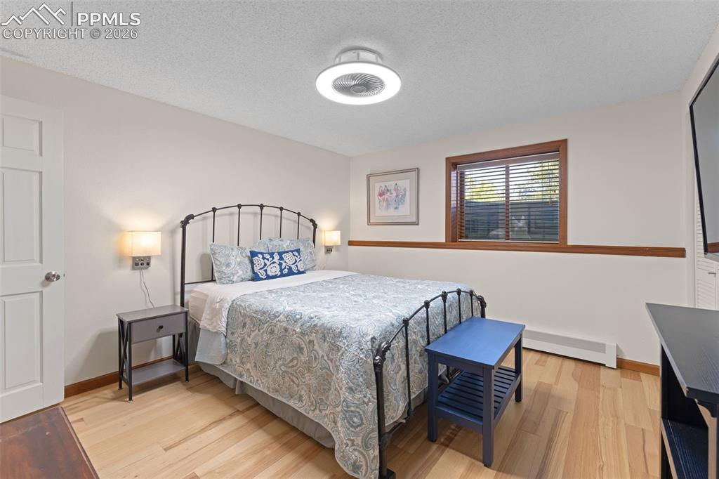 1851 Buttercup Road Elizabeth, CO 80107 - Photo 33 of 47 a bedroom with a bed and wooden floor