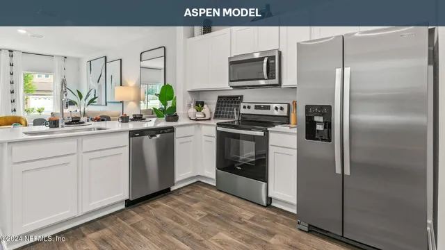 a kitchen with stainless steel appliances a microwave a sink and a refrigerator
