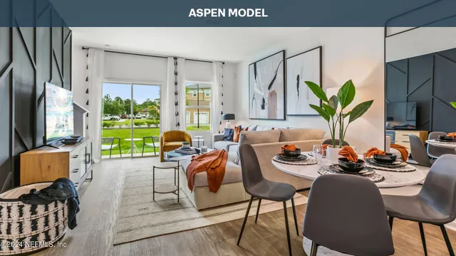 a living room with furniture kitchen view and a large window