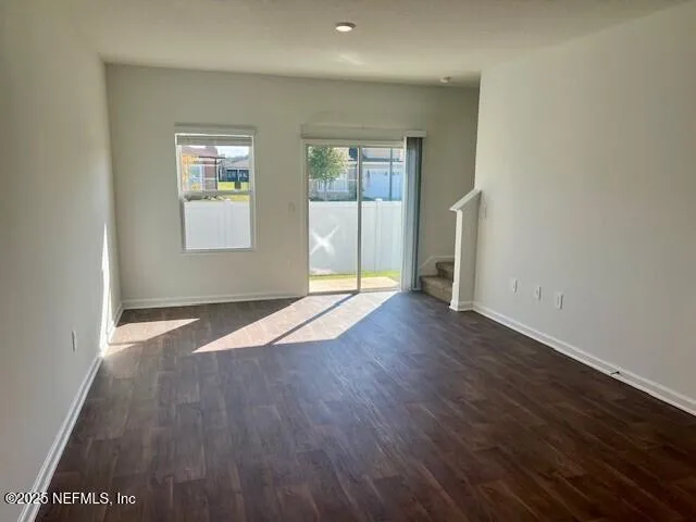 a living room with furniture a flat screen tv and a large window