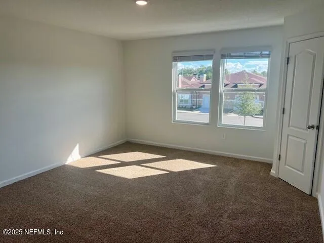 a bedroom with bed and a large window