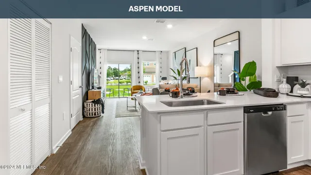 a kitchen with stainless steel appliances granite countertop a sink a stove a microwave and wooden cabinets