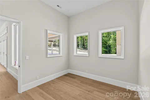 an empty room with windows and closet