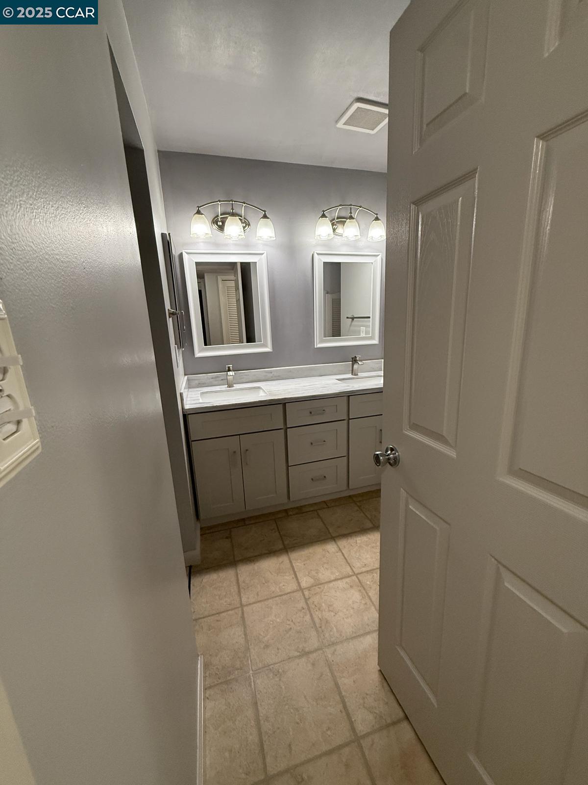 2061 Vanderslice Avenue Walnut Creek, CA 94596 - Photo 8 of 15 a bathroom with a double vanity sink and mirror
