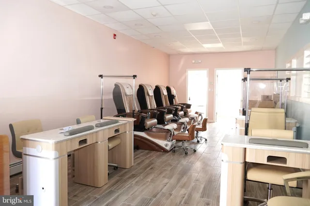 a view of a kitchen with fridge and wooden floor