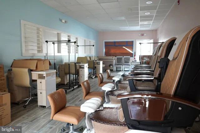 a living room with furniture a rug and white walls