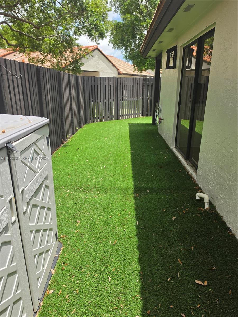15240 Southwest 45th Terrace, Unit 54F Miami, FL 33185 - Photo 47 of 48 a view of a backyard with wooden fence