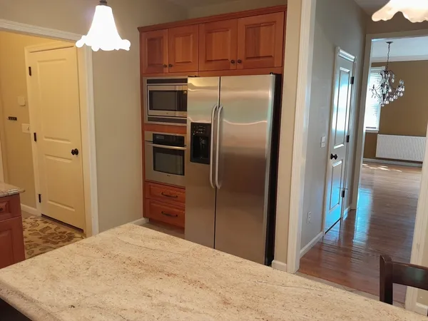 a kitchen with stainless steel appliances granite countertop a refrigerator and a sink
