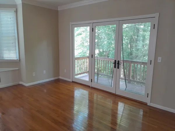 wooden floor in an empty room with a window