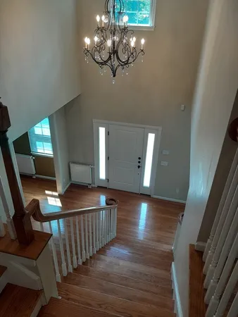 a view of a livingroom with furniture wooden floor and chandelier