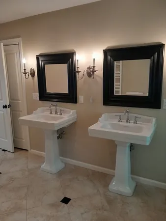 a bathroom with a sink a mirror and a toilet