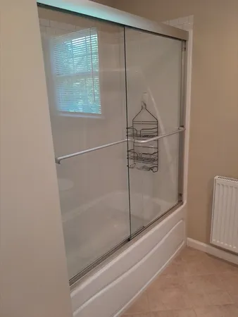 a bathroom with a glass shower door