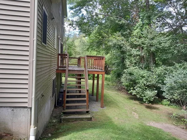 a view of a yard with plants and a stairs