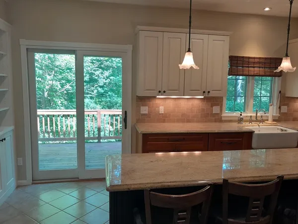 a kitchen with a table chairs and a window
