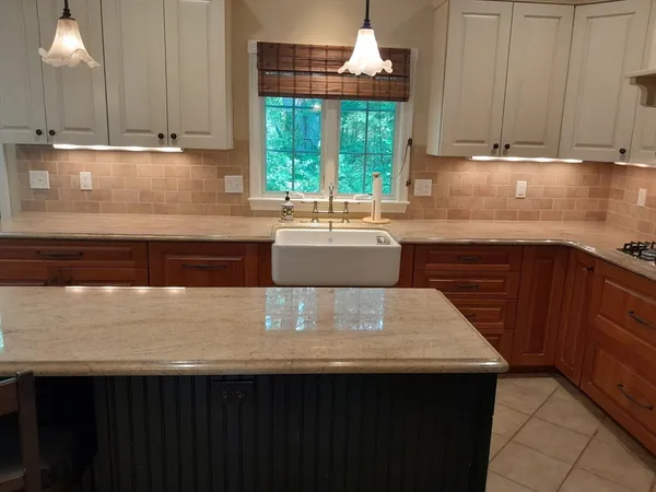 a view of kitchen with wooden cabinets and window