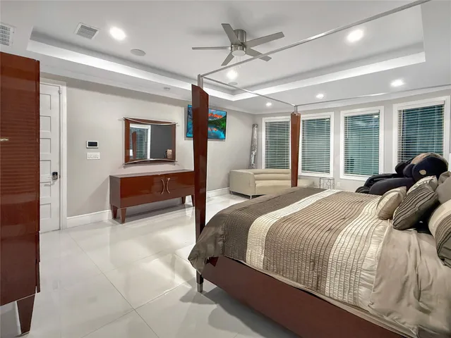 a bedroom with a large bed and a tv