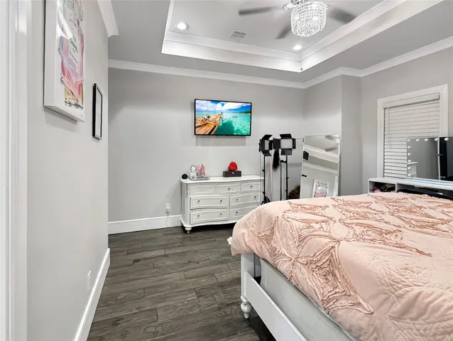 a bedroom with a bed and a chandelier