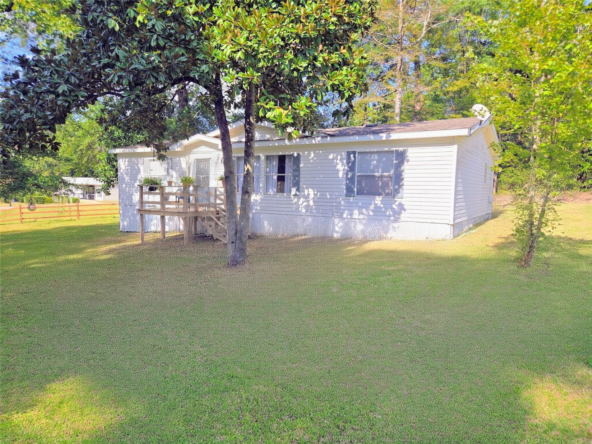 a view of a house with garden and trees