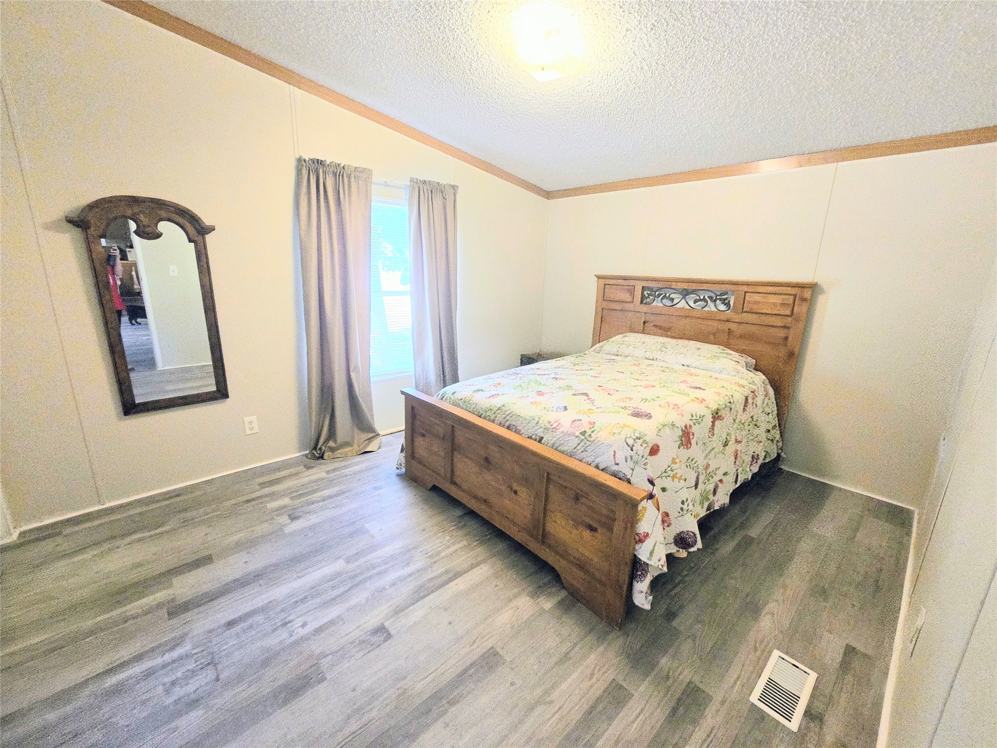 118 Noel Livingston, TX 77351 - Photo 7 of 13 a bed sitting in a spacious bedroom next to a window