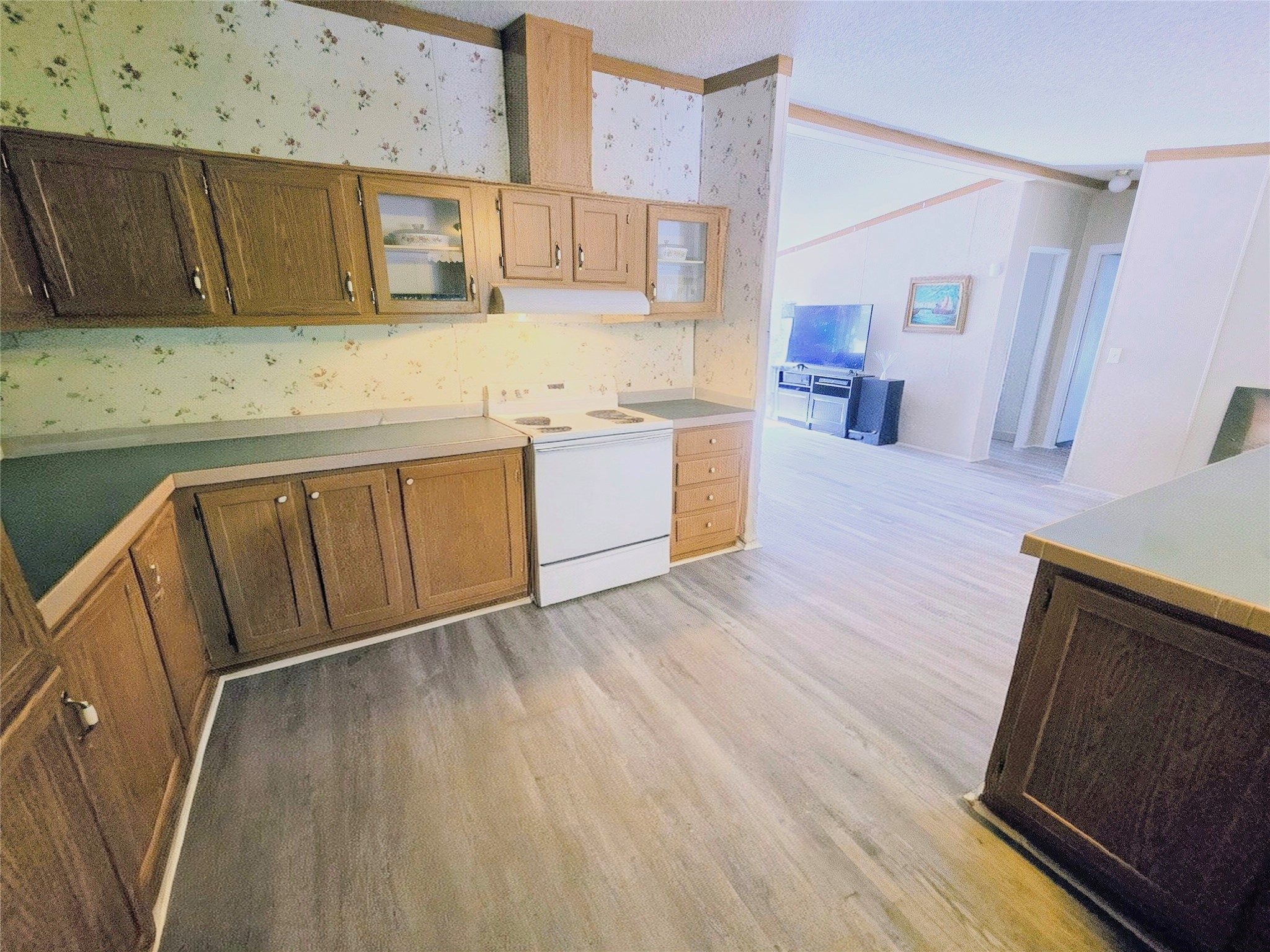 118 Noel Livingston, TX 77351 - Photo 9 of 13 a kitchen with wooden floors and white cabinets