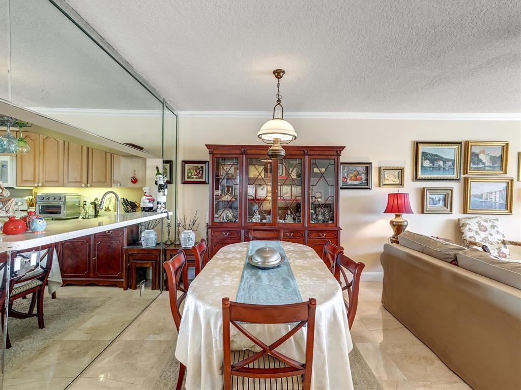 3050 Northeast 48th Court, Unit 401 Lighthouse Point, FL 33064 - Photo 16 of 53 a very nice looking dining room with a table and chairs