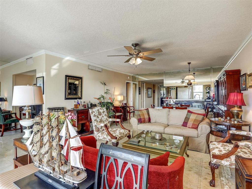 3050 Northeast 48th Court, Unit 401 Lighthouse Point, FL 33064 - Photo 17 of 53 a living room with furniture flat screen tv and a lamp