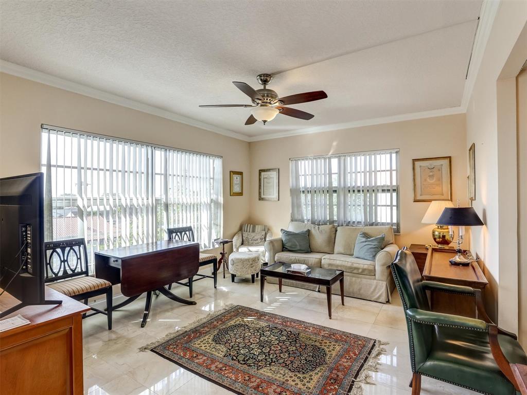 3050 Northeast 48th Court, Unit 401 Lighthouse Point, FL 33064 - Photo 22 of 53 a living room with furniture a table and a large window