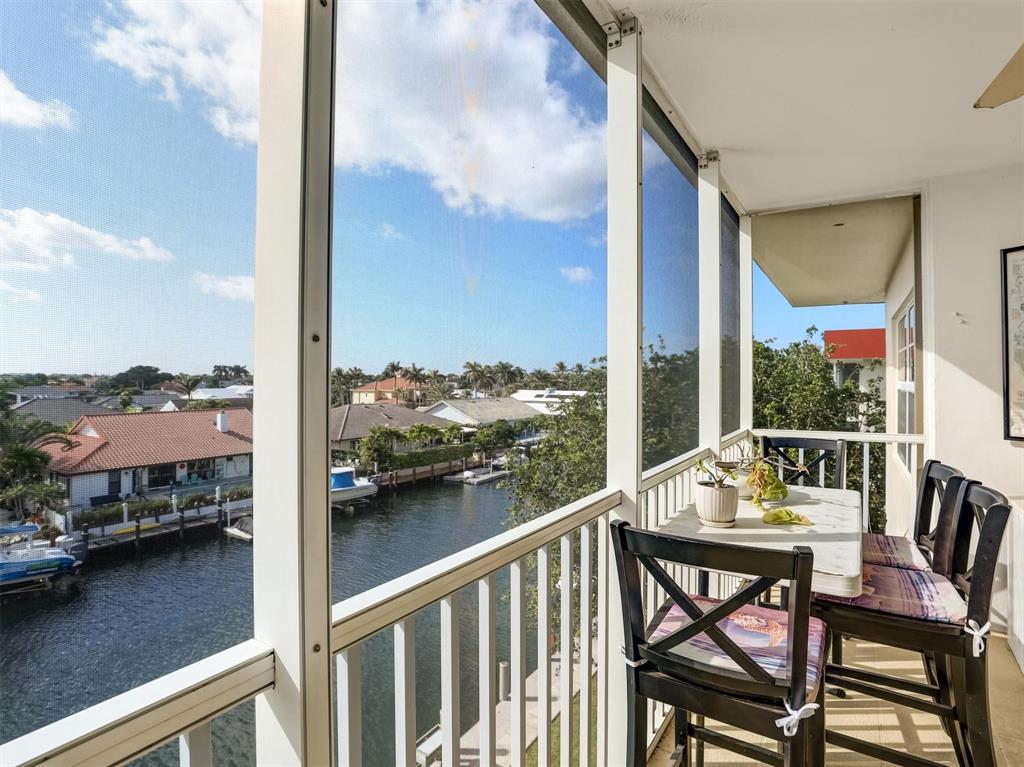 3050 Northeast 48th Court, Unit 401 Lighthouse Point, FL 33064 - Photo 24 of 53 a view of a balcony with chairs and a table