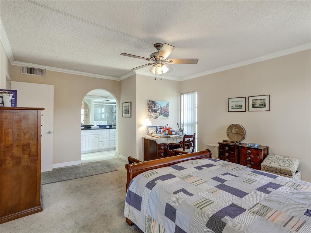 3050 Northeast 48th Court, Unit 401 Lighthouse Point, FL 33064 - Photo 29 of 53 a bedroom with a bed and a chandelier