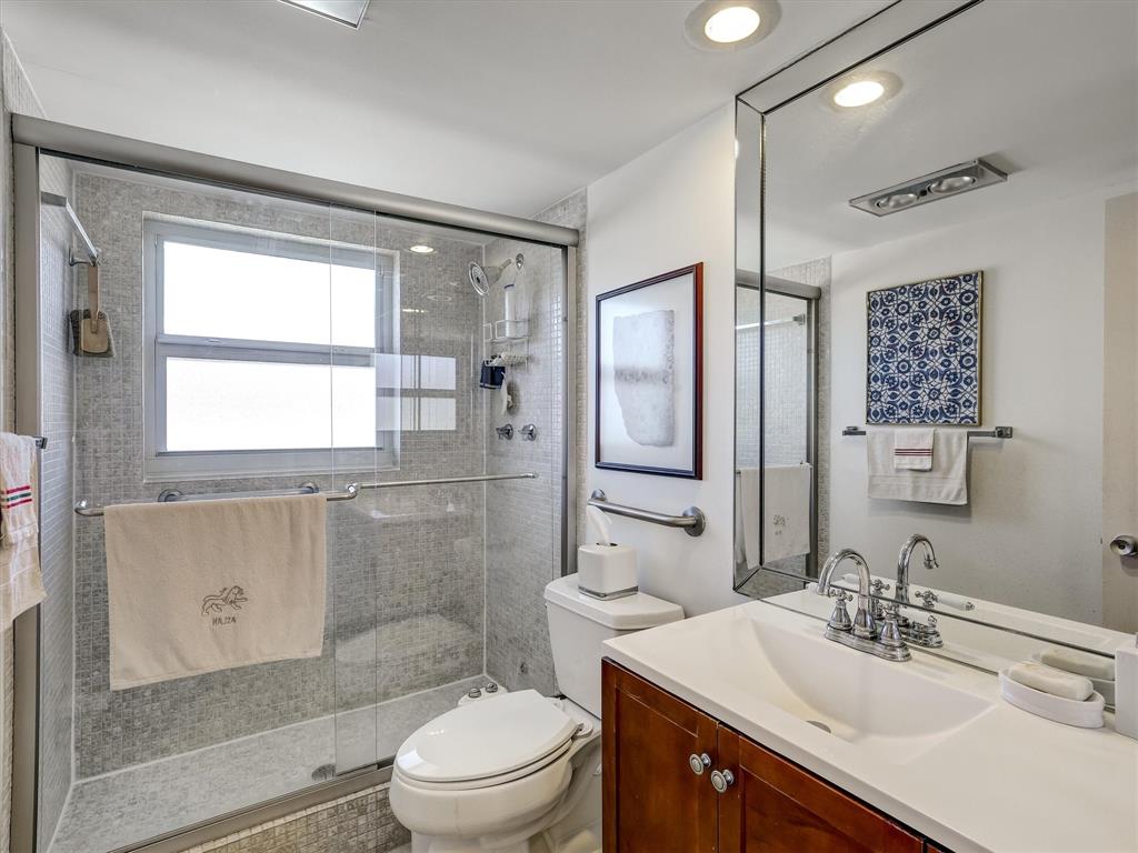 3050 Northeast 48th Court, Unit 401 Lighthouse Point, FL 33064 - Photo 34 of 53 a bathroom with a sink toilet vanity and shower