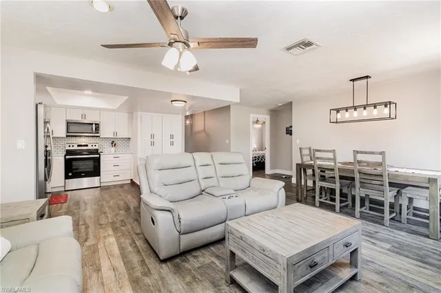 a living room with furniture and wooden floor