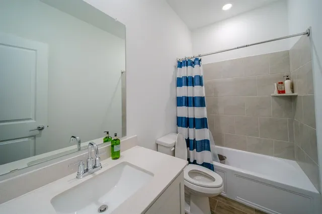 a bathroom with a sink toilet and shower