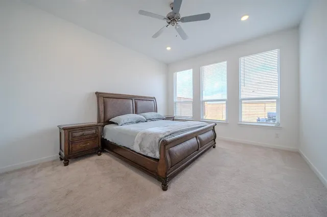a spacious bedroom with a bed and a window