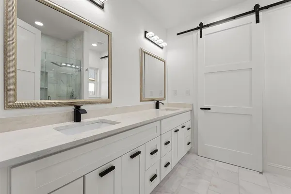 a bathroom with a double vanity sink and mirror