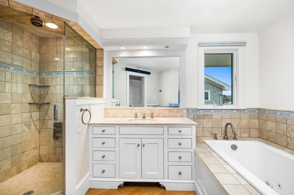 67 Surfside Road Scituate, MA 02066 - Photo 30 of 41 a bathroom with a granite countertop sink mirror bathtub and shower
