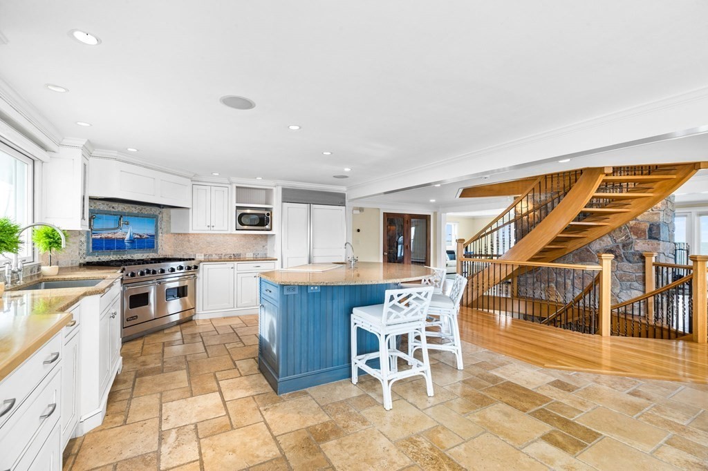 67 Surfside Road Scituate, MA 02066 - Photo 7 of 41 a kitchen with stainless steel appliances kitchen island granite countertop a sink and cabinets
