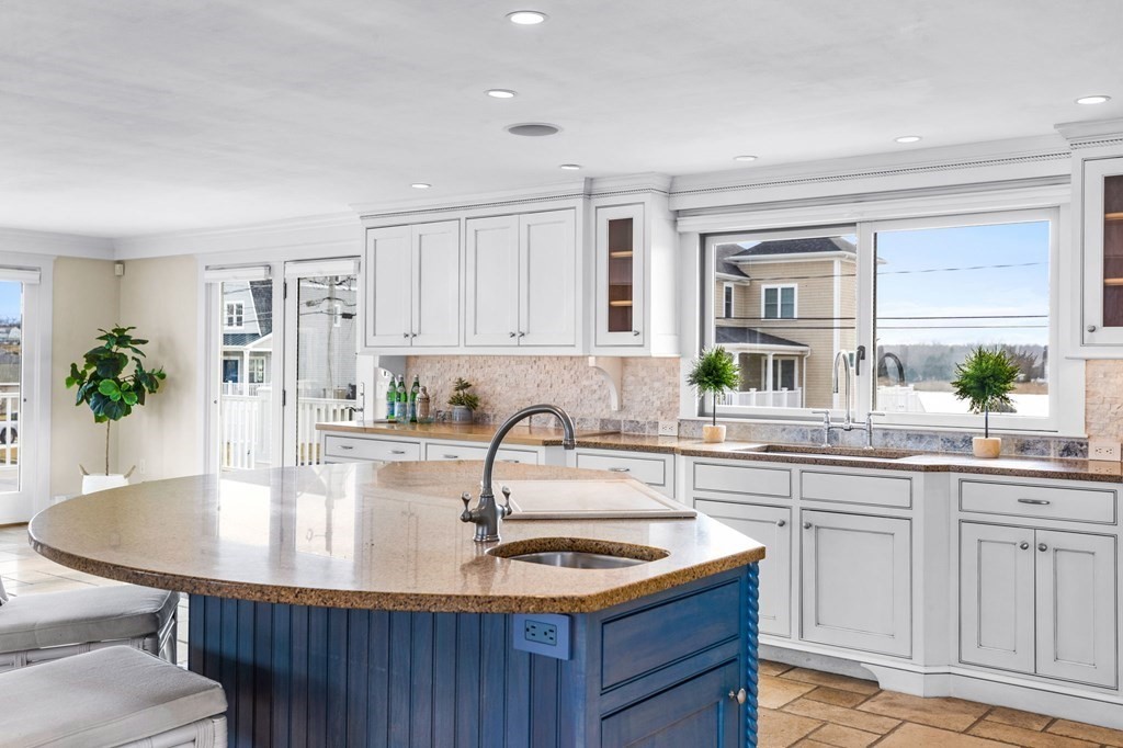 67 Surfside Road Scituate, MA 02066 - Photo 9 of 41 a kitchen with granite countertop a sink and cabinets