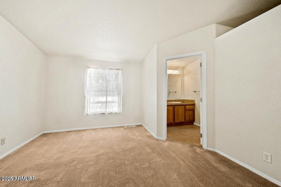 2421 West Thornton Road Show Low, AZ 85901 - Photo 21 of 48 a big room with windows and a kitchen view