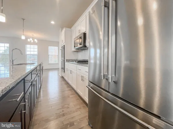 a kitchen with stainless steel appliances a refrigerator and a sink